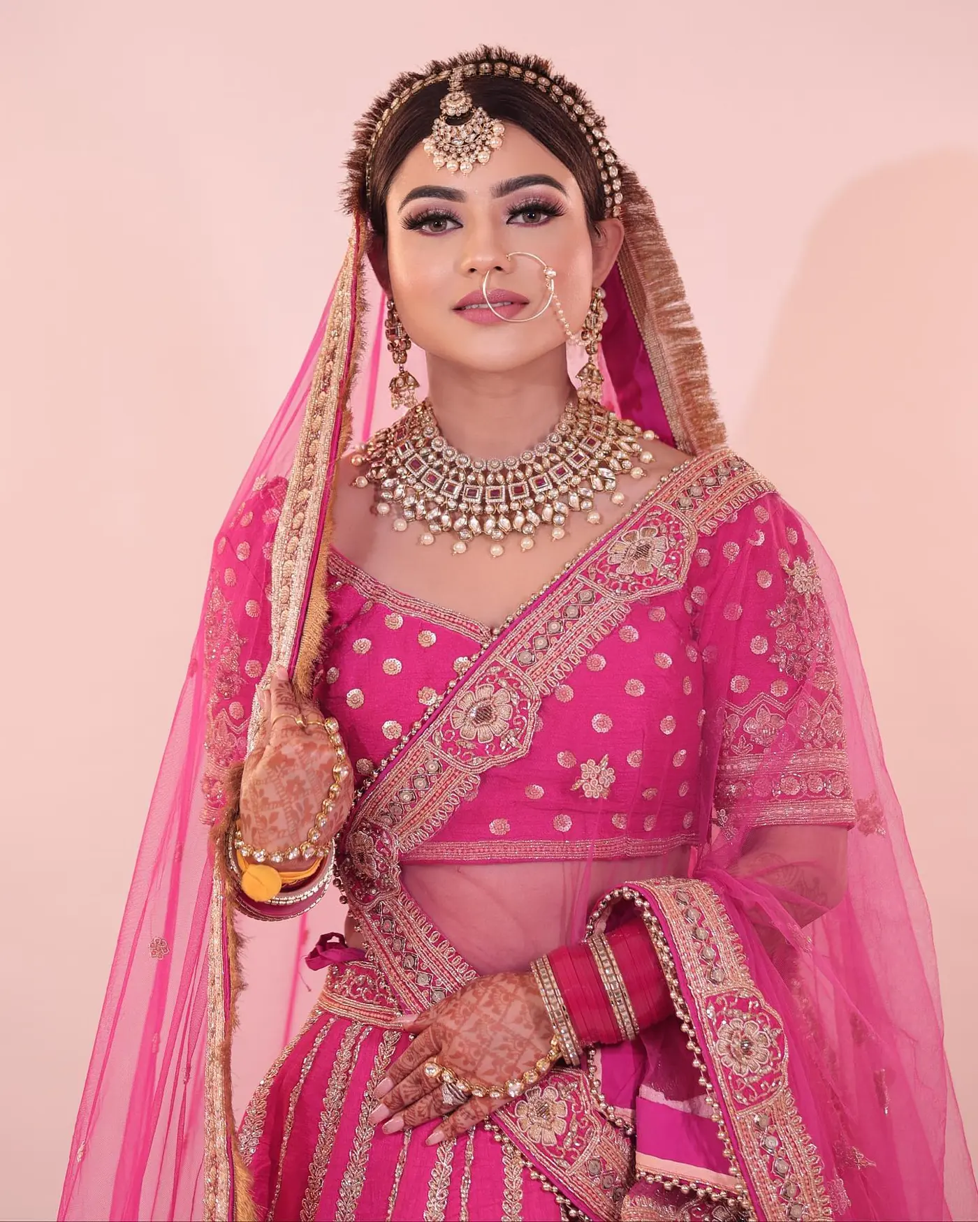 Magenta Lehenga, Pink Net Dupatta. Bridal makeup by Madhu Gupta at MG Makeovers, Gurugram